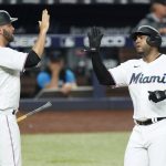 
              Miami Marlins' Jacob Stallings (58) and Jesus Aguilar congratulate each other after they both scored on a single by Jesus Sanchez during the second inning of a baseball game against the Seattle Mariners, Friday, April 29, 2022, in Miami. (AP Photo/Wilfredo Lee)
            