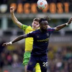 
              Burnley's Maxwel Cornet, right, and Norwich City's Sam Byram battle for the ball during the English Premier League soccer match between Norwich City and Burnley at Carrow Road, Norwich, England, Sunday April 10, 2022. (Adam Davy/PA via AP)
            