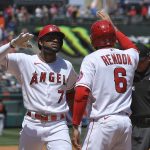 
              Los Angeles Angels' Jo Adell, left, is congratulated by Anthony Rendon after hitting a grand slam during the first inning of a baseball game against the Baltimore Orioles Sunday, April 24, 2022, in Anaheim, Calif. (AP Photo/Mark J. Terrill)
            