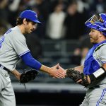 
              Toronto Blue Jays starting pitcher Jordan Romano, left, celebrates with catcher Alejandro Kirk after a baseball game against the New York Yankees, Monday, April 11, 2022, in New York. The Blue Jays won 3-0. (AP Photo/Frank Franklin II)
            