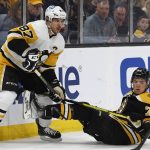 
              Pittsburgh Penguins' Sidney Crosby bumps Boston Bruins' Charlie McAvoy during the first period of an NHL hockey game Saturday, April 16, 2022, in Boston. (AP Photo/Winslow Townson)
            