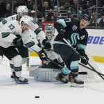 
              San Jose Sharks goaltender Kaapo Kahkonen, rear, watches as Seattle Kraken center Yanni Gourde, right, vie for the puck with San Jose Sharks left wing Matt Nieto (83) during the second period of an NHL hockey game Friday, April 29, 2022, in Seattle. (AP Photo/Ted S. Warren)
            