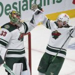 
              Minnesota Wild goaltender Cam Talbot (33) celebrates with Dmitry Kulikov (7) after the Wild defeated the Montreal Canadiens in an NHL hockey game Tuesday, April 19, 2022, in Montreal. (Ryan Remiorz/The Canadian Press via AP)
            