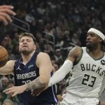 
              Dallas Mavericks' Luka Doncic, left, is fouled by Milwaukee Bucks' Wesley Matthews (23) while driving to the basket during the first half of an NBA basketball game Sunday, April 3, 2022, in Milwaukee. (AP Photo/Aaron Gash)
            