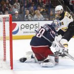 
              Boston Bruins forward Jake DeBrusk, right, scores past Columbus Blue Jackets goalie Elvis Merzlikins during the first period of an NHL hockey game in Columbus, Ohio, Monday, April 4, 2022. (AP Photo/Paul Vernon)
            