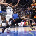 
              Utah Jazz guard Jordan Clarkson, center, passes the ball as he falls to the floor in front of Dallas Mavericks guard Josh Green (8) and Jazz's Rudy Gobert (27) in the first half of Game 2 of an NBA basketball first-round playoff series, Monday, April 18, 2022, in Dallas. (AP Photo/Tony Gutierrez)
            