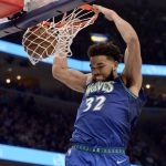
              Minnesota Timberwolves center Karl-Anthony Towns (32) dunks the ball in the second half during Game 1 of a first-round NBA basketball playoff series against the Memphis Grizzlies Saturday, April 16, 2022, in Memphis, Tenn. (AP Photo/Brandon Dill)
            