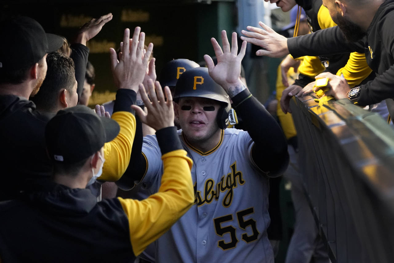 Pittsburgh Pirates' Roberto Perez celebrates in the dugout after scoring on Daniel Vogelbach's two-...