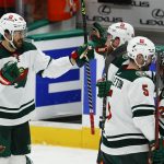 
              Minnesota Wild forward Frederick Gaudreau (89) is congratulated by teammates after scoring the winning goal in overtime of an NHL hockey game against the Dallas Stars, Thursday, April 14, 2022, in Dallas. (AP Photo/Brandon Wade)
            