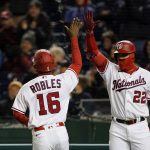 
              Washington Nationals' Victor Robles celebrates with Juan Soto (22) after Robles scored on a double by Cesar Hernandez during the sixth inning in the second game of a baseball doubleheader against the Arizona Diamondbacks at Nationals Park, Tuesday, April 19, 2022, in Washington. (AP Photo/Alex Brandon)
            