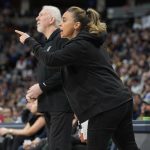 
              San Antonio Spurs assistant coach Becky Hammon, front, talks to players, next to coach Gregg Popovich during the first half of the team's NBA basketball game against the Denver Nuggets on Tuesday, April 5, 2022, in Denver. (AP Photo/David Zalubowski)
            