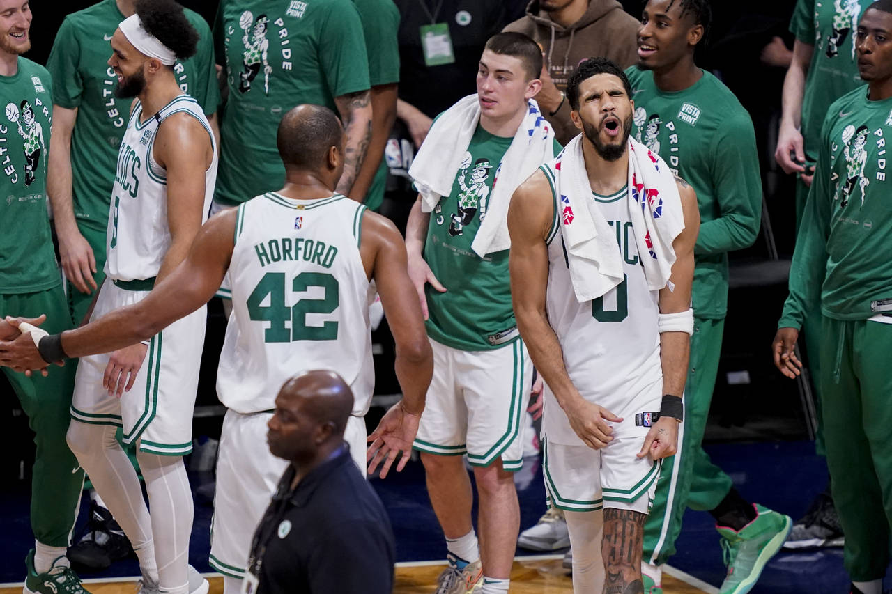 Boston Celtics forward Jayson Tatum (0) celebrates as his team holds the lead in the final seconds ...