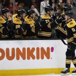 
              Boston Bruins' Trent Frederic is congratulated at the bench after scoring against the Pittsburgh Penguins during the first period of an NHL hockey game Saturday, April 16, 2022, in Boston. (AP Photo/Winslow Townson)
            