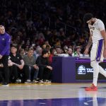 
              Los Angeles Lakers forward Anthony Davis, right, leaves the game after his ankle seemed to be bothering him while head coach Frank Vogel watches during the first half of an NBA basketball game against the Denver Nuggets Sunday, April 3, 2022, in Los Angeles. (AP Photo/Mark J. Terrill)
            