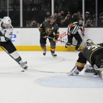 
              Vegas Golden Knights goaltender Logan Thompson (36) knocks the puck away from San Jose Sharks center Logan Couture (39) during the third period of an NHL hockey game Sunday, April 24, 2022, in Las Vegas. (AP Photo/John Locher)
            