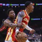 
              Miami Heat guard Kyle Lowry, left, attempts to steal the ball from Atlanta Hawks forward John Collins during the first half of Game 3 of an NBA basketball first-round Eastern Conference playoff series Friday, April 22, 2022, in Atlanta. (AP Photo/Brett Davis)
            