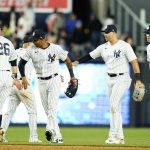 
              New York Yankees' DJ LeMahieu, left, and Aaron Hicks, second from left, celebrate with teammates after a baseball game Thursday, April 14, 2022, in New York. (AP Photo/Frank Franklin II)
            