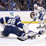 
              Tampa Bay Lightning goaltender Andrei Vasilevskiy (88) makes a save on a shot from Toronto Maple Leafs left wing Michael Bunting (58) during the first period of an NHL hockey game Monday, April 4, 2022, in Tampa, Fla. (AP Photo/Jason Behnken)
            