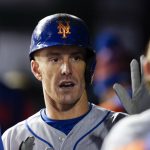 New York Mets' Mark Canha is greeted in the dugout after scoring on a force  out ground ball by Starling Marte during the fifth inning of an opening day  baseball game against