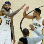 
              New Orleans Pelicans forward Brandon Ingram (14) high fives guard CJ McCollum after Game 2 of an NBA basketball first-round playoff series against the Phoenix Suns, Tuesday, April 19, 2022, in Phoenix. The Pelicans defeated the Suns 125-114. (AP Photo/Matt York)
            
