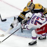 
              New York Rangers' Frank Vatrano (77) tries to get a shot on Boston Bruins' Linus Ullmark (35) during the second period of an NHL hockey game, Saturday, April 23, 2022, in Boston. (AP Photo/Michael Dwyer)
            