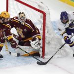 
              Minnesota State's Ryan Sandelin (14) tries to get the puck past Minnesota's Justen Close (1) as Mike Koster (6) defends during the first period of an NCAA men's Frozen Four men's hockey semifinal Thursday, April 7, 2022, in Boston. (AP Photo/Michael Dwyer)
            