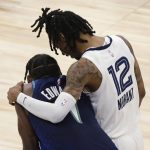 
              Memphis Grizzlies guard Ja Morant (12) consoles Minnesota Timberwolves forward Anthony Edwards (1) late in the second half of Game 6 in an NBA basketball first-round playoff series Friday, April 29, 2022, in Minneapolis. (AP Photo/Andy Clayton-King)
            