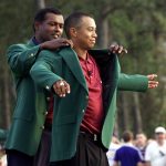 
              FILE - Tiger Woods, right, receiving his Masters green jacket from champion Vijay Singh, of Fiji, after winning the 2001 Masters at the Augusta National Golf Club in Augusta, Ga., April 8, 2001. In a 25-person survey, this ranked as his third-most significant Masters title. (AP Photo/Doug Mills, File)
            