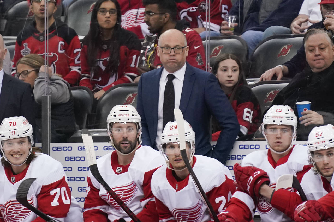 Detroit Red Wings head coach Jeff Blashill, center, looks over the ice during the first period of a...