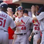 
              St. Louis Cardinals' Harrison Bader (48) celebrates with teammates after scoring on an RBI-single hit by Andrew Knizner during the second inning of a baseball game against the Cincinnati Reds, Saturday, April 23, 2022, in Cincinnati. (AP Photo/Jeff Dean)
            