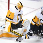 
              Pittsburgh Penguins' Brian Dumoulin (8) blocks a shot in front of goalie Casey DeSmith (1) during the first period of the team's NHL hockey game against the Boston Bruins in Pittsburgh, Thursday, April 21, 2022. (AP Photo/Gene J. Puskar)
            