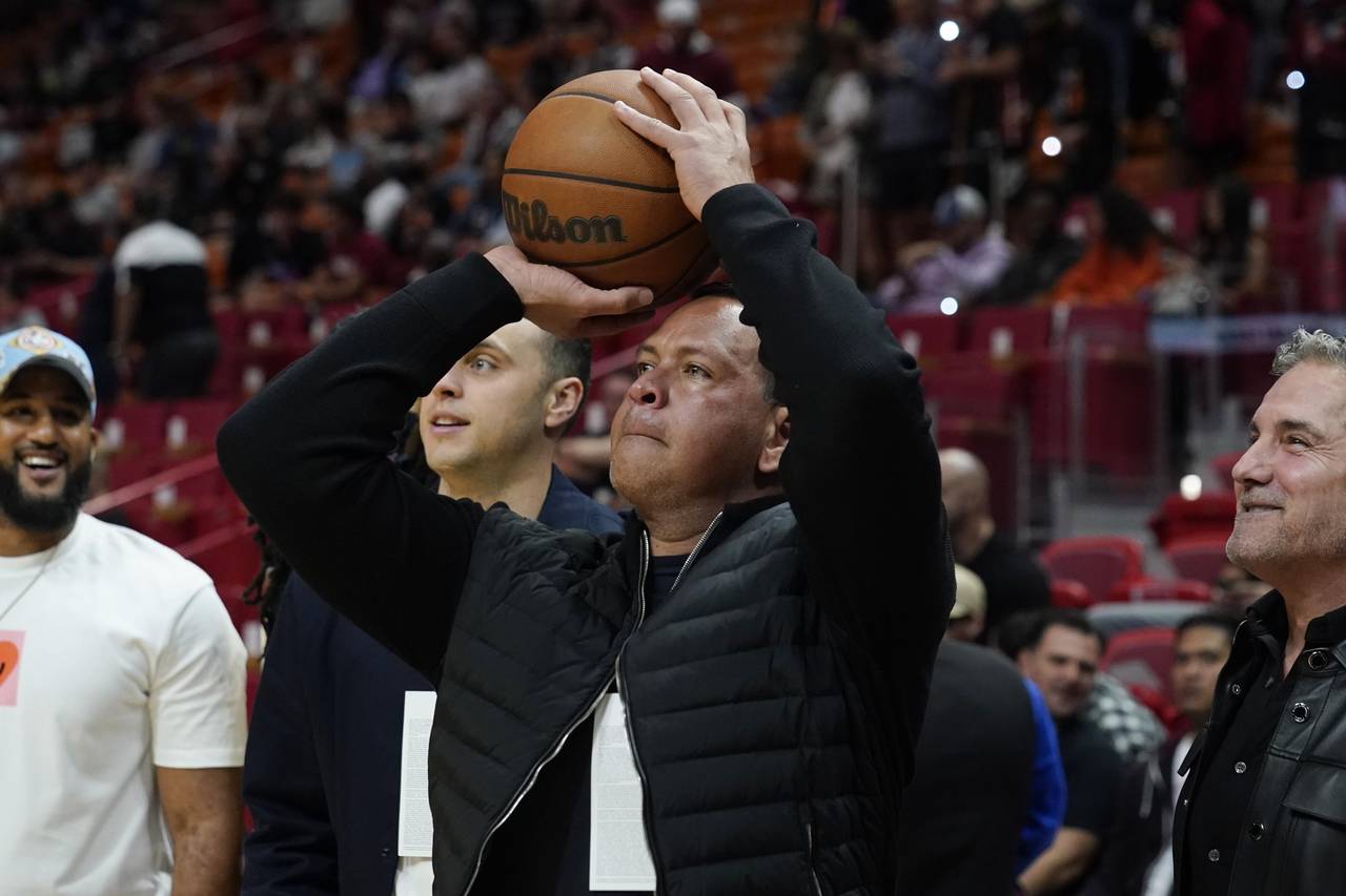 Alex Rodriguez, partial owner of the Minnesota Timberwolves NBA team aims a shot at the basket befo...