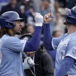 
              Kansas City Royals' Hunter Dozier, right, celebrates with Adalberto Mondesi (27) after hitting a two-run home run during the sixth inning of a baseball game against the Detroit Tigers Saturday, April 16, 2022, in Kansas City, Mo. (AP Photo/Charlie Riedel)
            