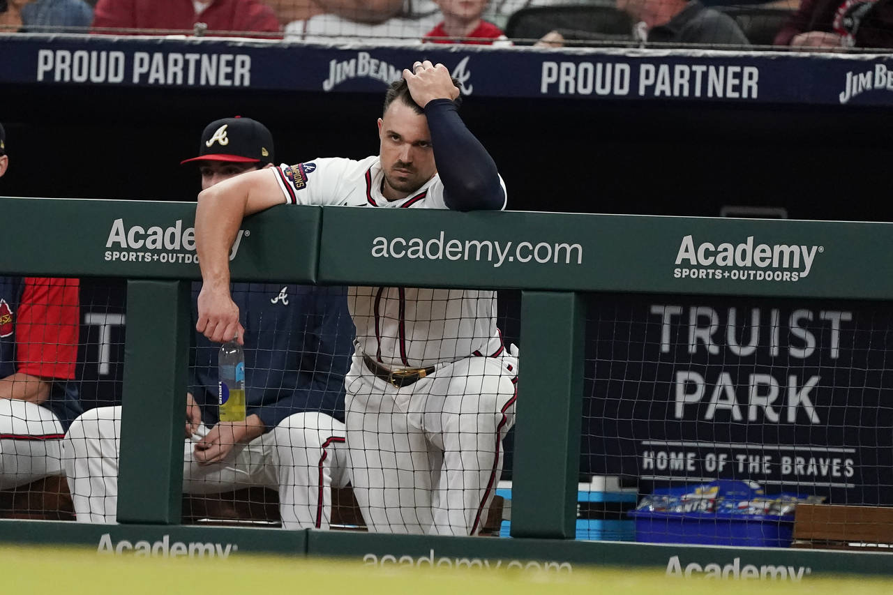 Atlanta Braves outfielder Adam Duvall watches from the dugout during a baseball game against the Wa...