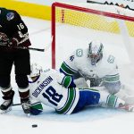 
              Arizona Coyotes left wing Andrew Ladd (16) has his shot stopped by Vancouver Canucks center Jason Dickinson (18) and Canucks goaltender Jaroslav Halak (41) during the first period of an NHL hockey game Thursday, April 7, 2022, in Glendale, Ariz. (AP Photo/Ross D. Franklin)
            