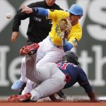 
              Boston Red Sox's Trevor Story, top right, gets the throw as Minnesota Twins' Jorge Polanco (11) attempts to steal second base during the first inning of a baseball game, Saturday, April 16, 2022, in Boston. (AP Photo/Michael Dwyer)
            