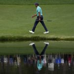
              Tiger Woods walks along the 16th fairway during the second round at the Masters golf tournament on Friday, April 8, 2022, in Augusta, Ga. (AP Photo/Charlie Riedel)
            