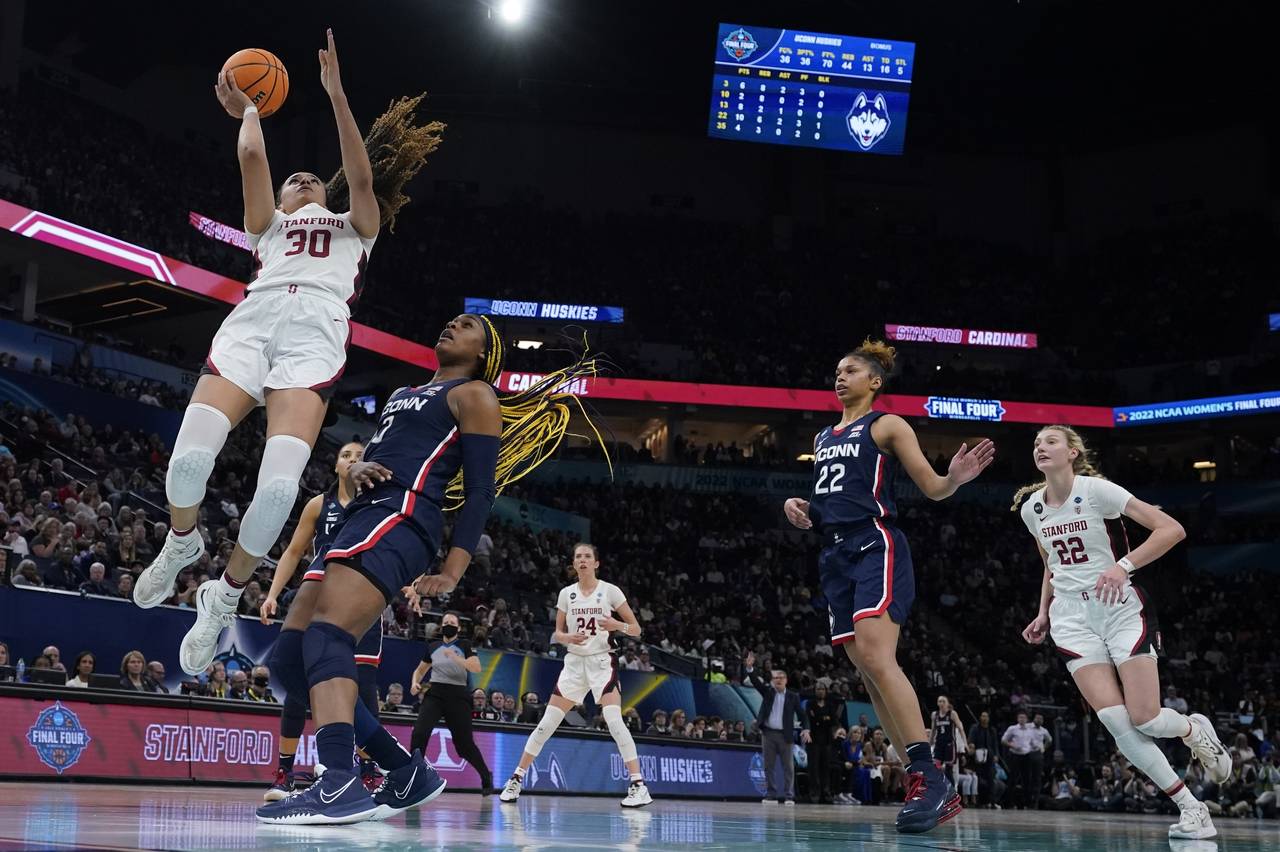 Stanford's Haley Jones shoots past UConn's Aaliyah Edwards during the second half of a college bask...
