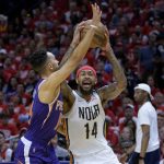 
              New Orleans Pelicans forward Brandon Ingram (14) shoots against Phoenix Suns guard Landry Shamet in the first half of Game 4 of an NBA basketball first-round playoff series in New Orleans, Sunday, April 24, 2022. (AP Photo/Matthew Hinton)
            