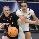 
              South Carolina's Brea Beal and Louisville's Hailey Van Lith go after a loose ball during the second half of a college basketball game in the semifinal round of the Women's Final Four NCAA tournament Friday, April 1, 2022, in Minneapolis. (AP Photo/Charlie Neibergall)
            