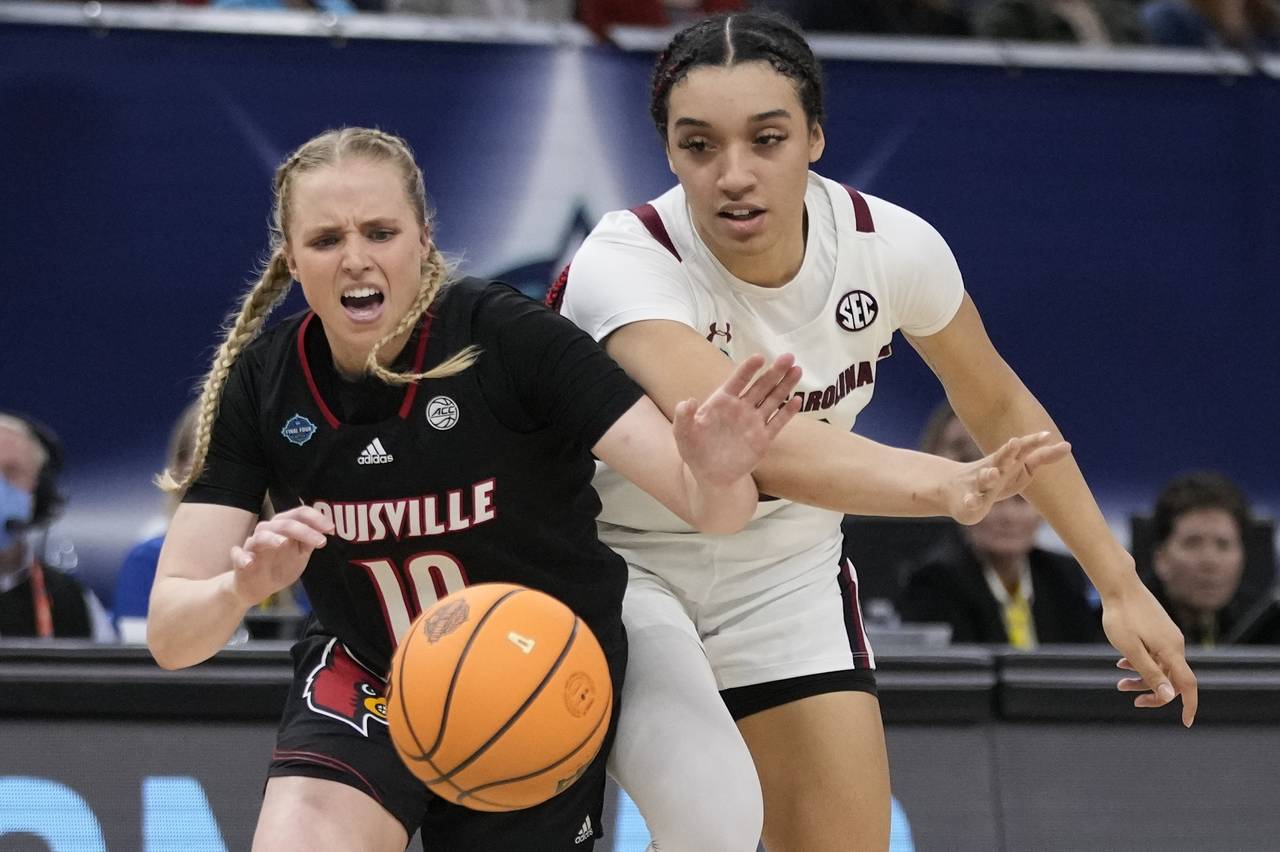South Carolina's Brea Beal and Louisville's Hailey Van Lith go after a loose ball during the second...