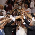 
              FILE - Miami Heat owner Micky Arison holds the Larry O'Brien NBA Championship Trophy after Game 5 of the NBA finals basketball series against the Oklahoma City Thunder, June 21, 2012, in Miami. The Heat won 121-106 to become the 2012 NBA Champions. (AP Photo/Wilfredo Lee, File)
            