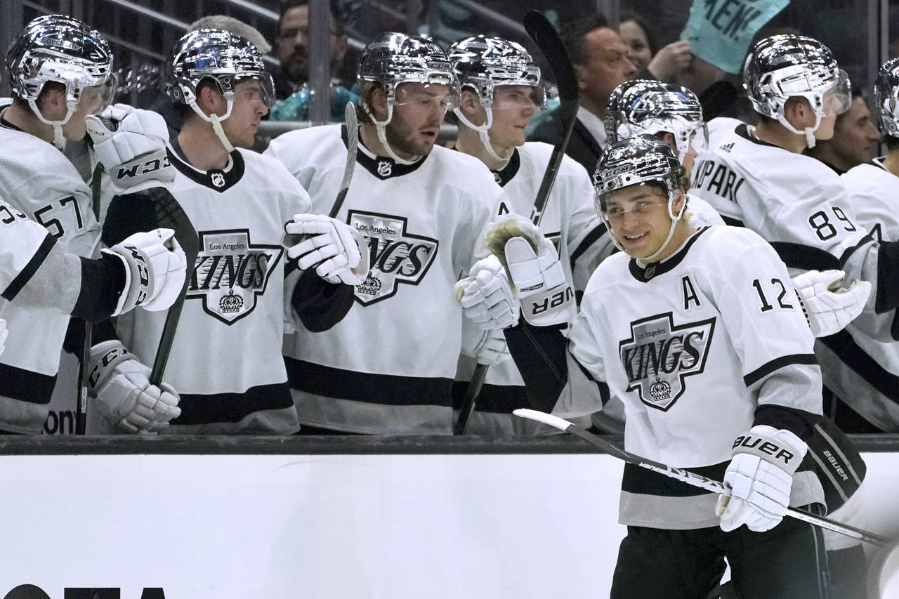 Los Angeles Kings center Trevor Moore (12) is congratulated by teammates after his goal against the...