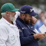 
              Shane Lowry, of Ireland, gets hugged by his caddie Brian Martin after putting out on the 18th hole during the second round at the Masters golf tournament on Friday, April 8, 2022, in Augusta, Ga. (AP Photo/Robert F. Bukaty)
            