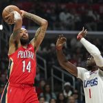 
              New Orleans Pelicans forward Brandon Ingram, left, shoots as Los Angeles Clippers guard Reggie Jackson defends during the first half of an NBA basketball game Sunday, April 3, 2022, in Los Angeles. (AP Photo/Mark J. Terrill)
            