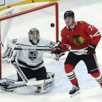 
              Los Angeles Kings goaltender Jonathan Quick (32) and Chicago Blackhawks center Kirby Dach (77) watch the puck during the third period of an NHL hockey game Tuesday, April 12, 2022, in Chicago. The Kings won 5-2. (AP Photo/Paul Beaty)
            