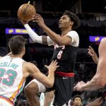 
              Portland Trail Blazers guard Keon Johnson (6) drives to the hoop against San Antonio Spurs forward Zach Collins (23) during the first half of an NBA basketball game Friday, April 1, 2022, in San Antonio. (AP Photo/Nick Wagner)
            