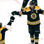 
              Boston Bruins center Patrice Bergeron, right, celebrates after scoring the third goal of his hat trick, during the third period of the team's NHL hockey game against the Buffalo Sabres, Thursday, April 28, 2022, in Boston. (AP Photo/Charles Krupa)
            