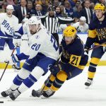 
              Tampa Bay Lightning left wing Nicholas Paul (20) gets around Nashville Predators center Nick Cousins (21) during the second period of an NHL hockey game Saturday, April 23, 2022, in Tampa, Fla. (AP Photo/Chris O'Meara)
            