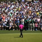 
              The gallery applauds Tiger Woods after his putt on the sixth hole during the first round at the Masters golf tournament on Thursday, April 7, 2022, in Augusta, Ga. (AP Photo/Charlie Riedel)
            